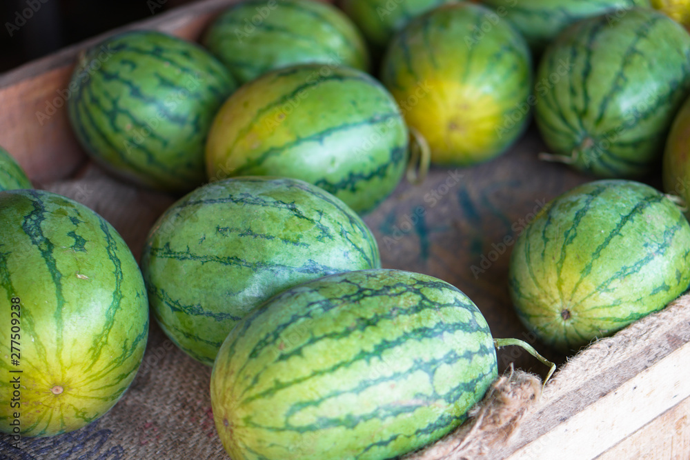 Watermelons and melons are sold on the market in Asia. Sale of vegetarian fruits outdoors. Stock photos Watermelons and melons are sold on the market in Asia. Sale of vegetarian fruits outdoors. Stock photos