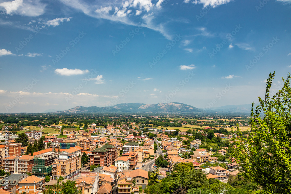 View of the valley of the Sacco River, from the ancient village of Artena. The Lepini mountains. The outskirts of the city. Houses and buildings. Real estate. The countryside and the cultivated fields