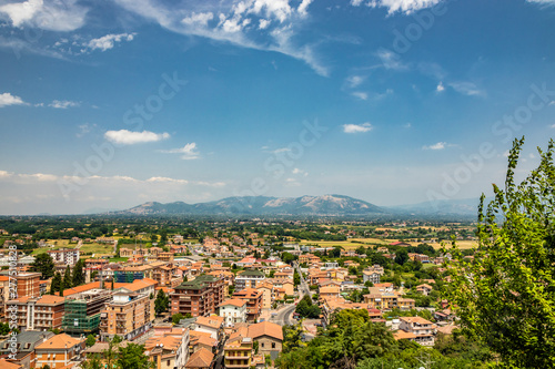 View of the valley of the Sacco River, from the ancient village of Artena. The Lepini mountains. The outskirts of the city. Houses and buildings. Real estate. The countryside and the cultivated fields