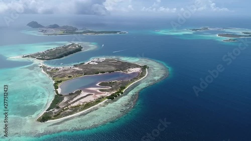 Moving-turn aerial view  beach cay  and-shallow-turquoise waters in the Caribbean sea in  Madrisky Los-roques National Park Venezuela photo