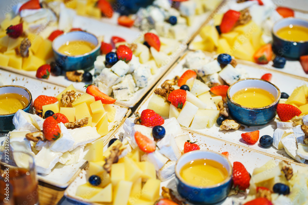 Slices of different cheese plate berries and honey. Slices of different cheese plate berries and honey.
