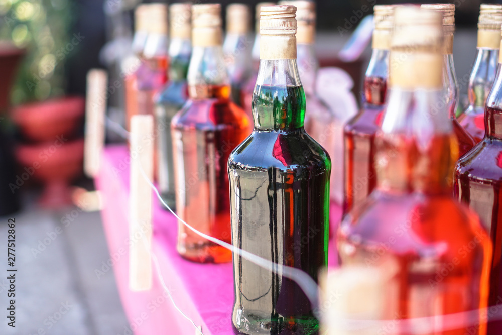 Multicolored bottled drinks outside. Stock photo background