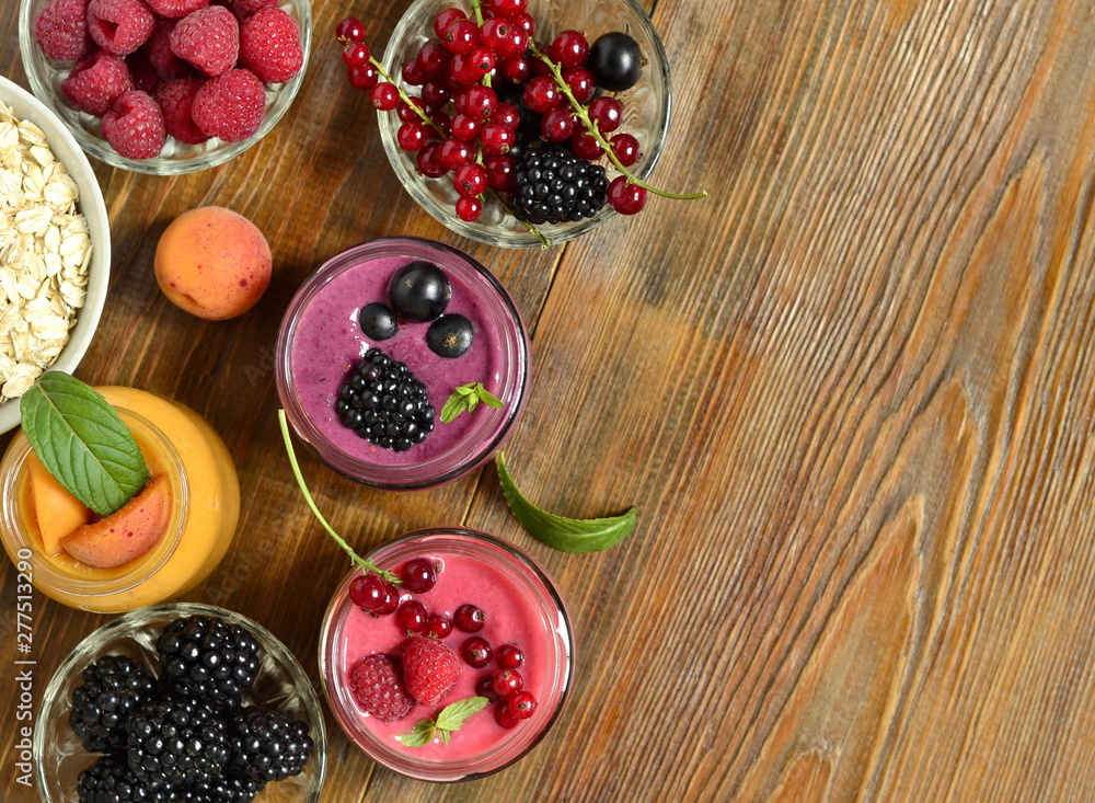 Oatmeal smoothies with various berries, view from above, copy space