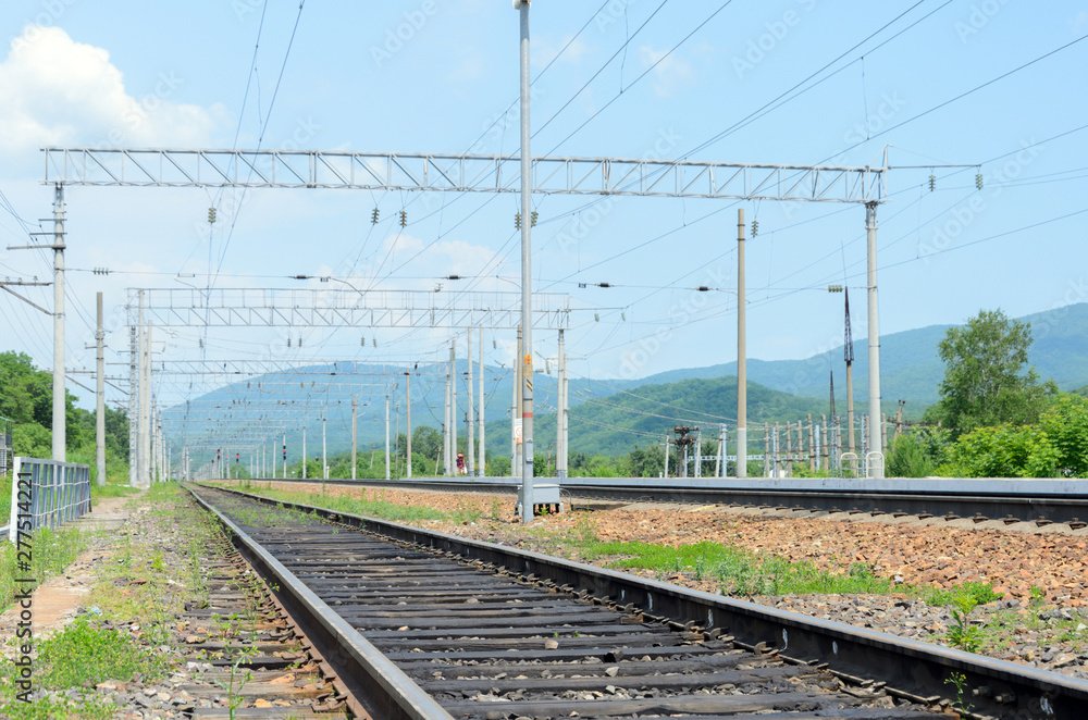 Railway tracks in mountainous terrain extending into perspective