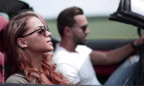 close up.a young woman with her boyfriend in a convertible car © ASDF