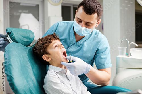 Dentist checks the child s teeth