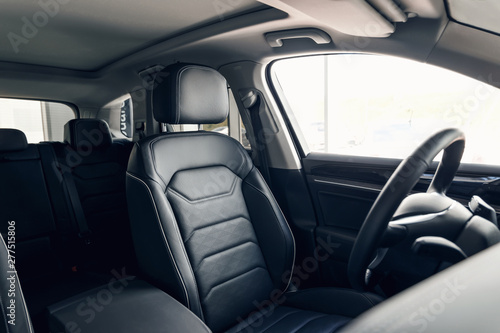 Black leather car interior. Modern car interior dashboard and steering wheel. Modern luxury car black perforated leather interior. Interior details © svetlichniy_igor