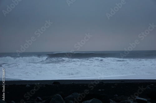 Black Rocks With Smashing Waves In The Background At Reynisfjara Beach In Iceland