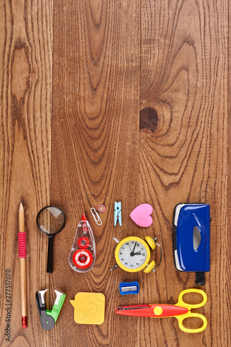School stationery composition on wooden background. Various school or office supplies with copy space. Flat lay, top view.