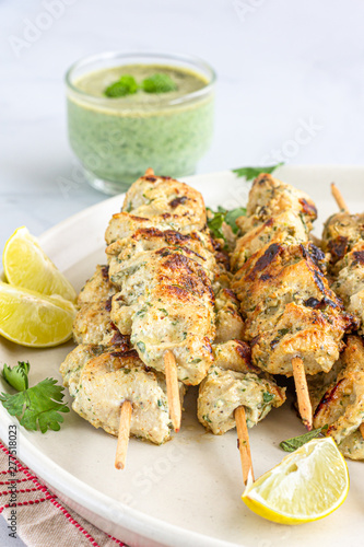 Vertical Photo of Indian Creamy Chicken Tikka Kebab with Lemon and Mint Vhutney. photo