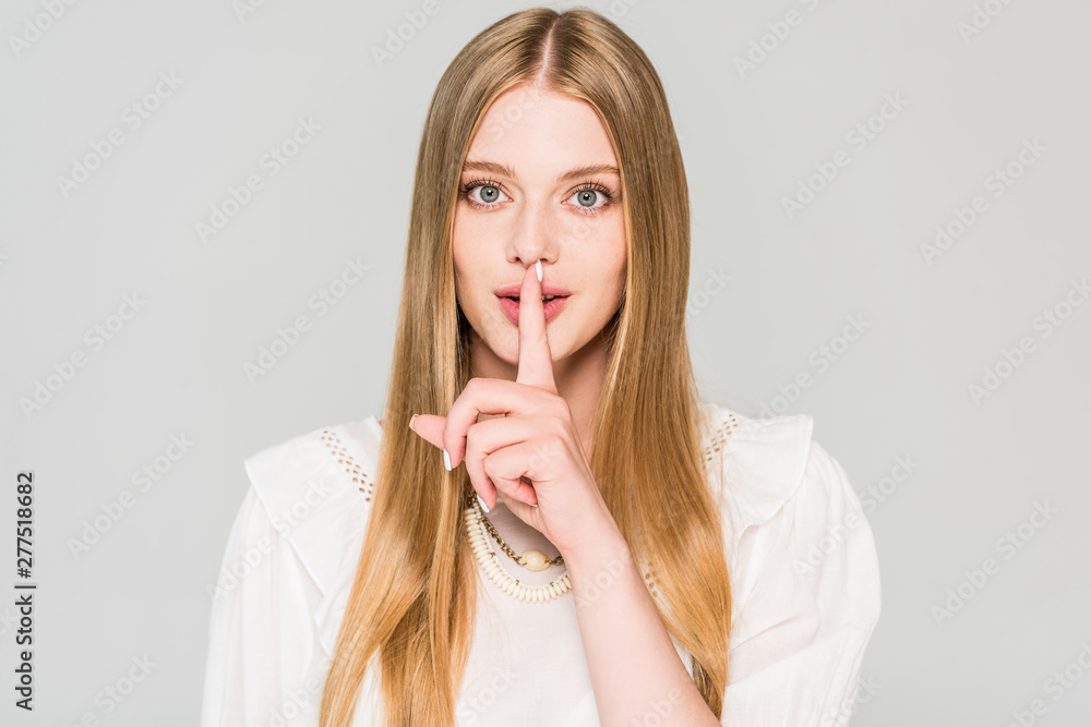 beautiful girl doing silence gesture isolated on grey beautiful girl doing silence gesture isolated on grey