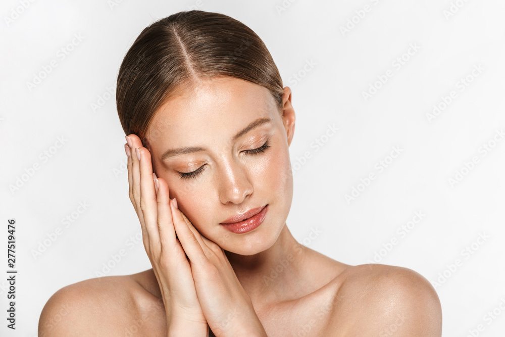 Image of calm half-naked woman posing at camera and holding palms together with eyes closed Image of calm half-naked woman posing at camera and holding palms together with eyes closed
