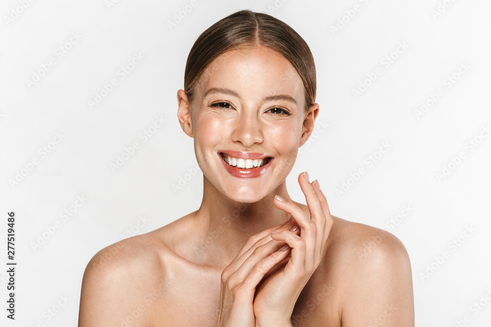 Image of alluring half-naked woman smiling at camera and holding hands together Image of alluring half-naked woman smiling at camera and holding hands together