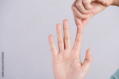 Healthcare and medical concept. Woman massaging her painful Index finger.