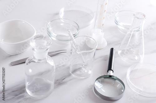 Different kinds of medical glassware, professional equipments on the laboratory testing table
