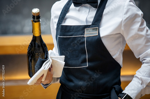  waiter in a restaurant with a bottle of prosecco