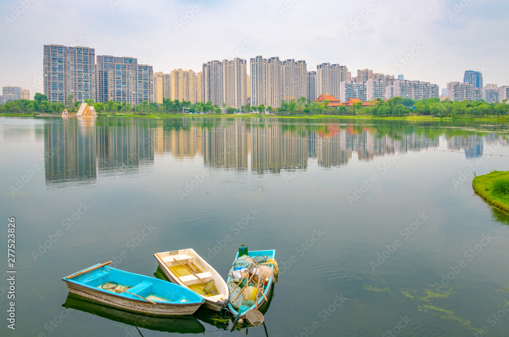 Buildings and garbage boats in Jincheng Lake, Chengdu, Sichuan Province, China