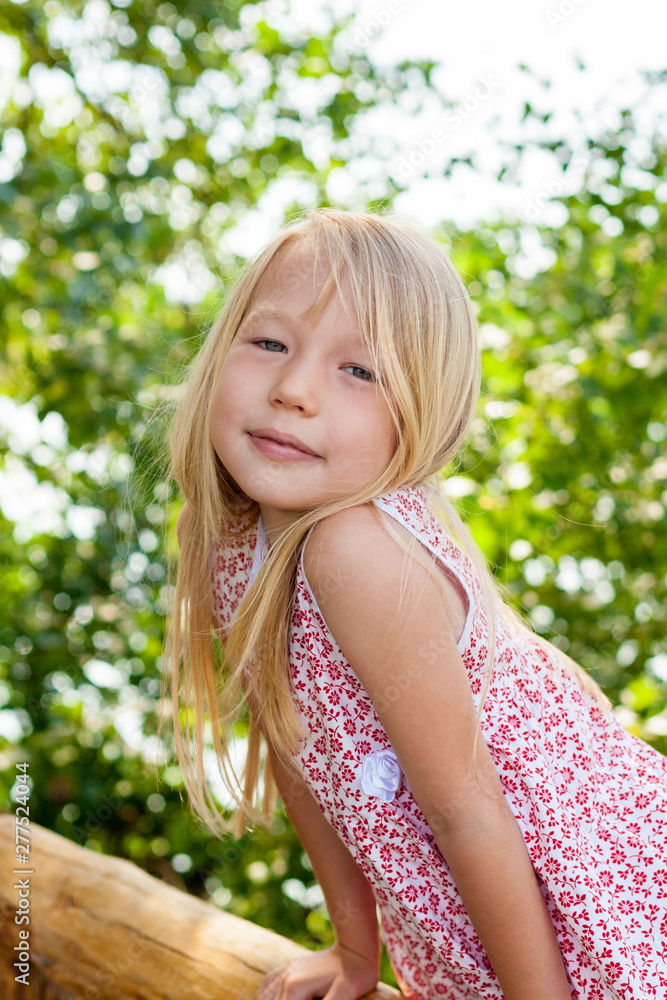 Portrait of little girl during a walk on the meadow outside the city. Active family time on nature. Hiking with little kids Portrait of little girl during a walk on the meadow outside the city. Active family time on nature. Hiking with little kids