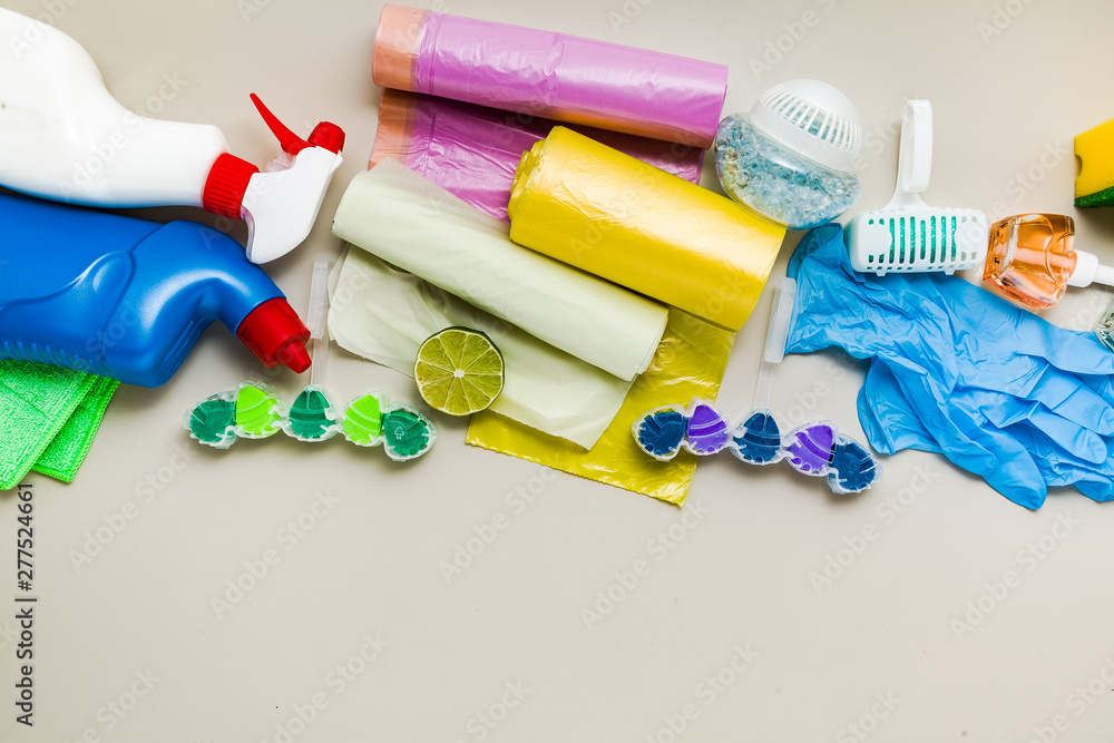 various detergents and the necessary attributes for cleaning, washing and ironing in the background. copy space