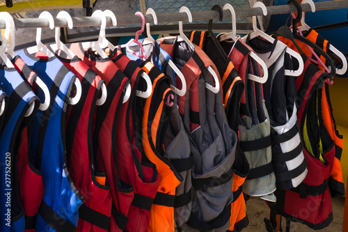 Life jackets on hanger closeup. Colorful life vests