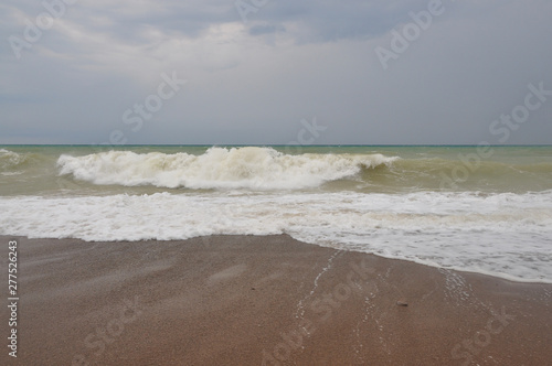 Stormy sea with high waves and beach