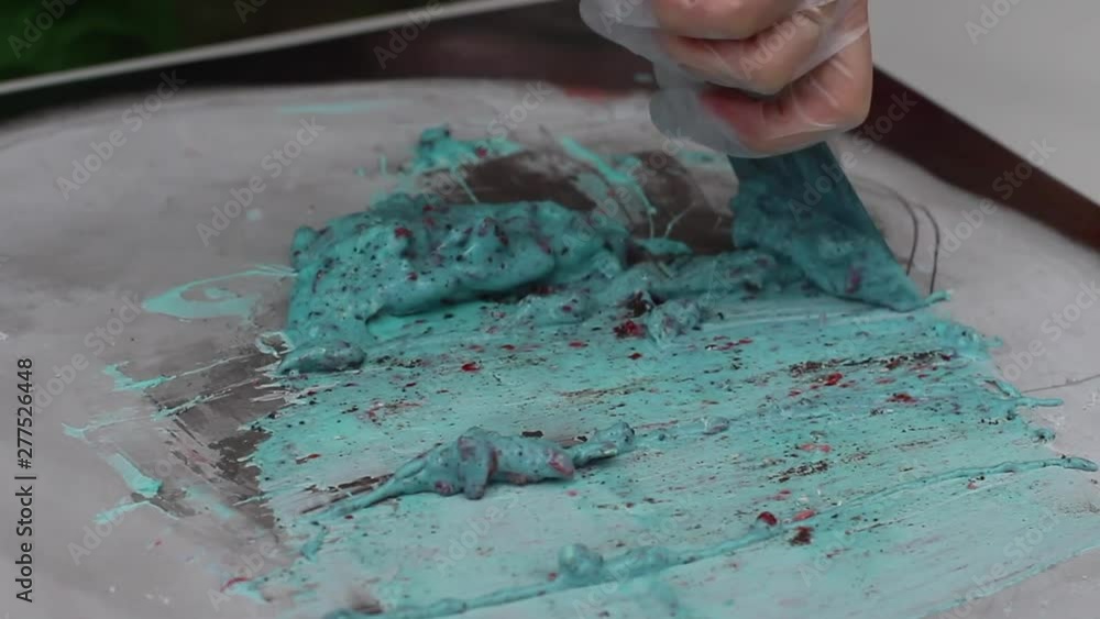 Preparing stir-fried ice cream rolls with strawbwerry at freeze pan. Rolled ice cream, hand made ice cream dessert. Preparing stir-fried ice cream rolls with strawbwerry at freeze pan. Rolled ice cream, hand made ice cream dessert.