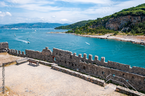 Portovenere, Italy. Seaside village with the gulf of poets that inspired the poems of Byron, a popular tourist destination for beach holidays and tracking. Church of San Pietro and Island of Palmaria. photo