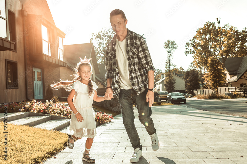 Obraz premium Stylish young father in checkered shirt and jeans playing with little girl