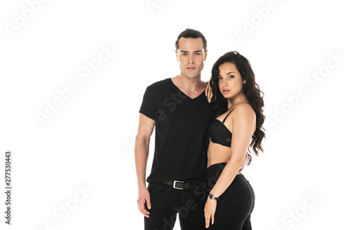 couple in black clothes embracing and looking at camera isolated on white