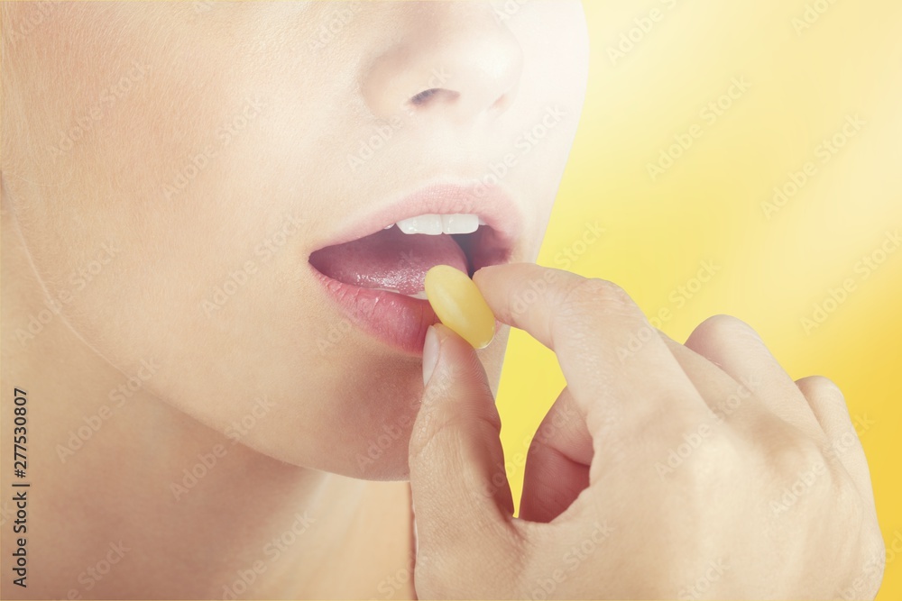 Woman taking pill, close up, healthcare concept Woman taking pill, close up, healthcare concept