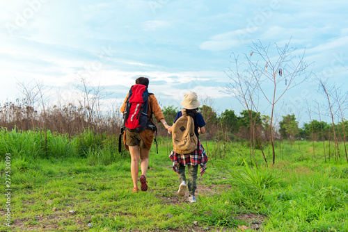 Mom and kid holding maps walking in the jungle forest with items travel backpacks for education nature. Travel Concept.