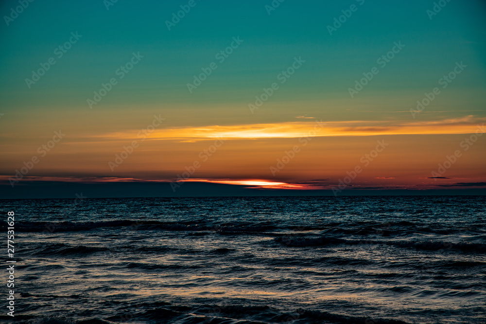 picturesque calm sunset with colorful clouds on the shores of the Baltic Sea in Poland picturesque calm sunset with colorful clouds on the shores of the Baltic Sea in Poland