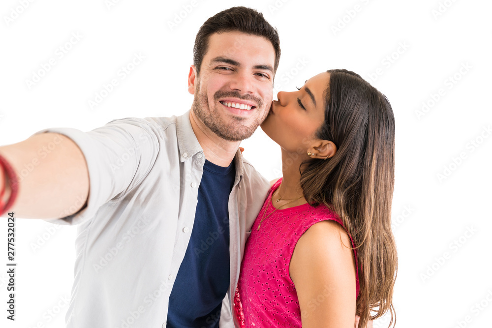 Girlfriend Kissing Smiling Latin Man In Studio Girlfriend Kissing Smiling Latin Man In Studio