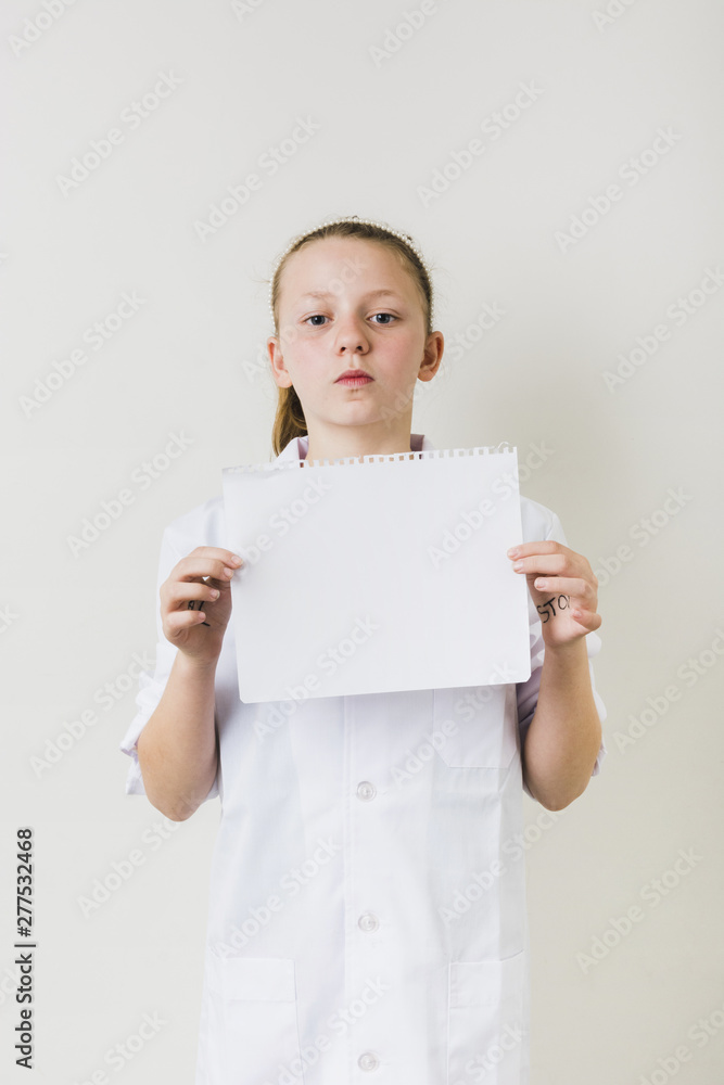 Confident little girl holding empty paper sheet Confident little girl holding empty paper sheet