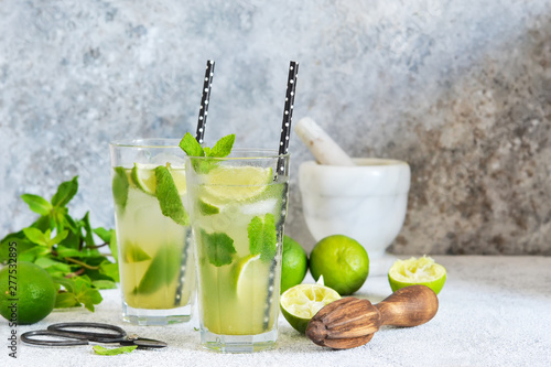 Mojito is a traditional summer cold drink with lime, mint and alcohol. Summer drink.