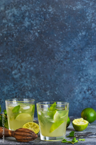 Summer cold drink - mahito with lime and mint on a concrete dark background.