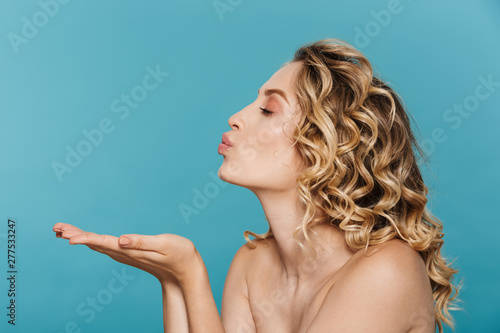 Canvas-taulu Image in profile of young shirtless woman 20s with curly blond hair blowing air