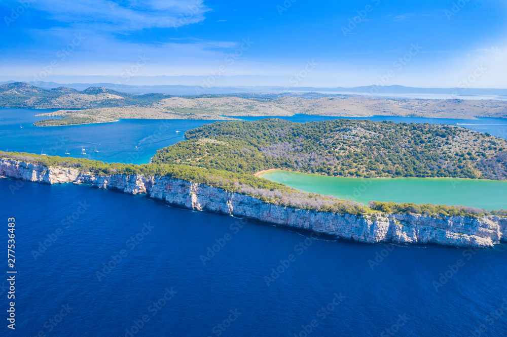 Fototapeta premium Aerial view of the Salt lake in nature park Telascica, Croatia, Dugi otok, big stone cliffs above the sea