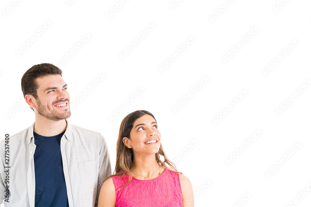 Smiling Man And Woman Staring At Something In Studio Smiling Man And Woman Staring At Something In Studio