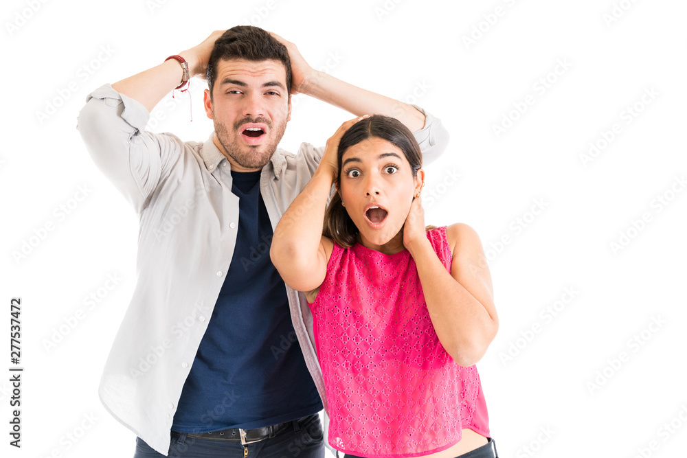 Shocked Couple With Mouth Open Against Plain Background Shocked Couple With Mouth Open Against Plain Background
