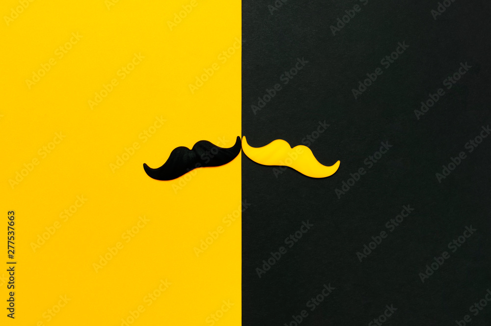 Creative party decoration concept. Black and yellow mustache, props for photo booths, carnival parties on black yellow background top view flat lay copy space Father's day Men's health awareness month - obrazy, fototapety, plakaty 