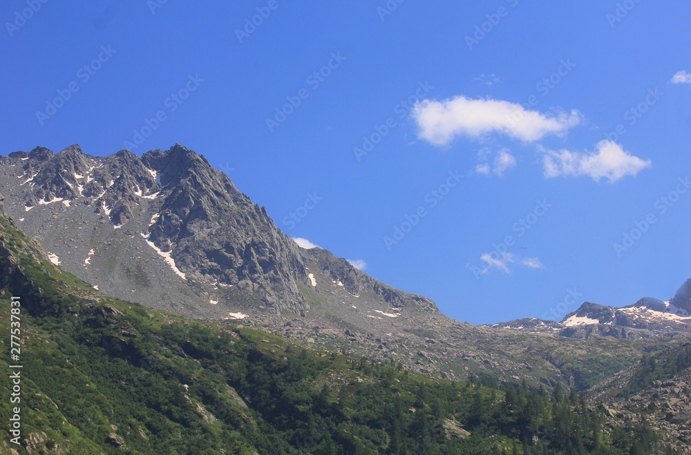 panorama with mountains, rocks, clouds and vegetation