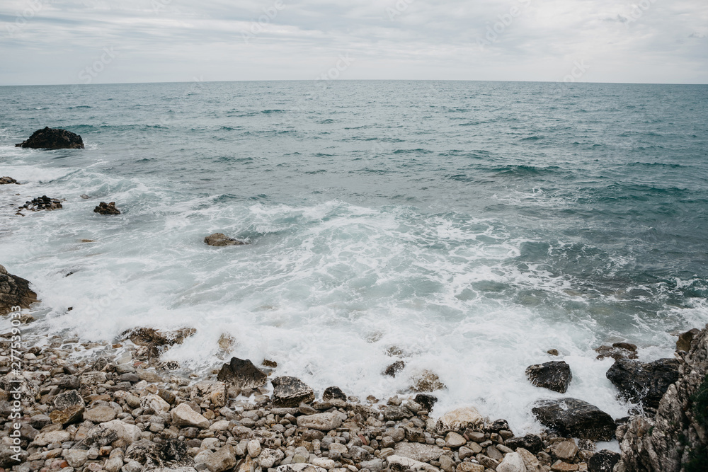 Restless sea near the stone coast. Surf. Natural landscape Restless sea near the stone coast. Surf. Natural landscape