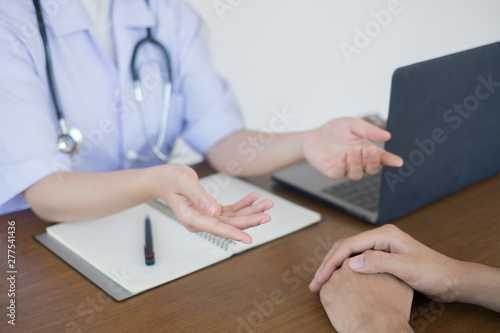 Doctor physician consulting with male patients in hospital exam room. Men's health concept