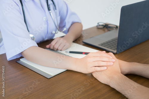 The doctor's hand makes the male patient confident.