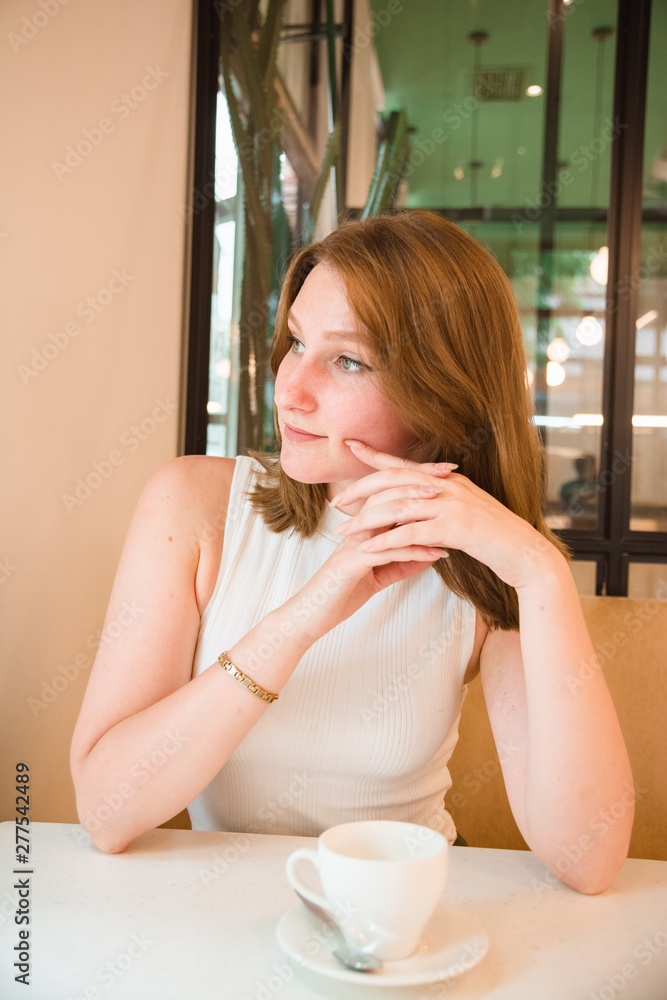 Girl is waiting for a meeting in cafe Girl is waiting for a meeting in cafe