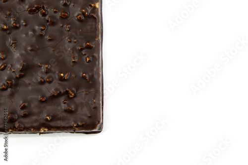 Small piece of chocolate cake with nuts on white background