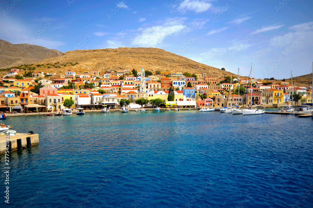 Elegant colorful houses on the shores of small coves can be considered the hallmark of the Dodecanese archipelago.