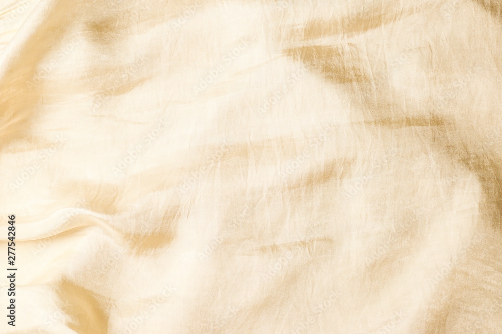 Naklejka premium Soft smooth beige silk fabric background. Fabric texture.