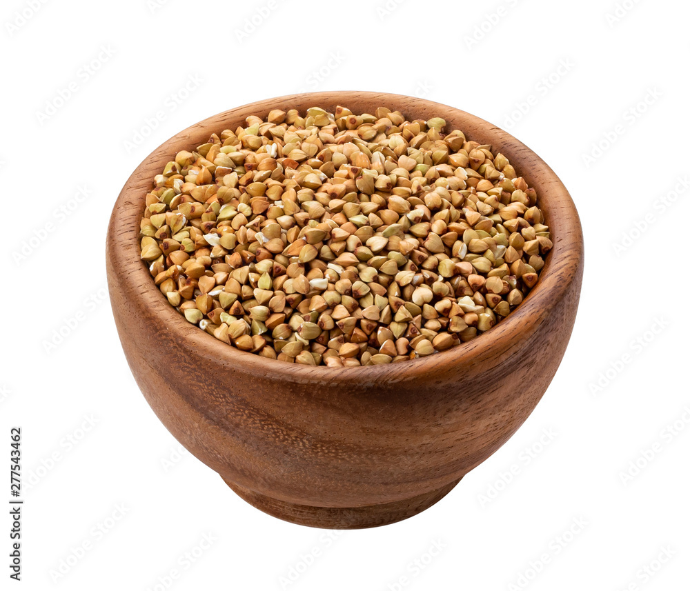 Brown wooden bowl with uncooked green buckwheat grain Brown wooden bowl with uncooked green buckwheat grain